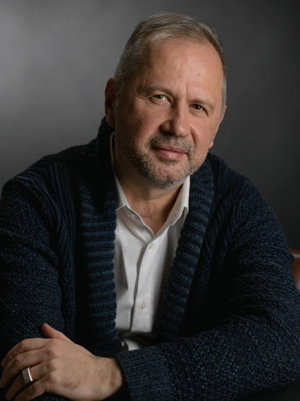 Олександр у затишній студії, спершись на стіл